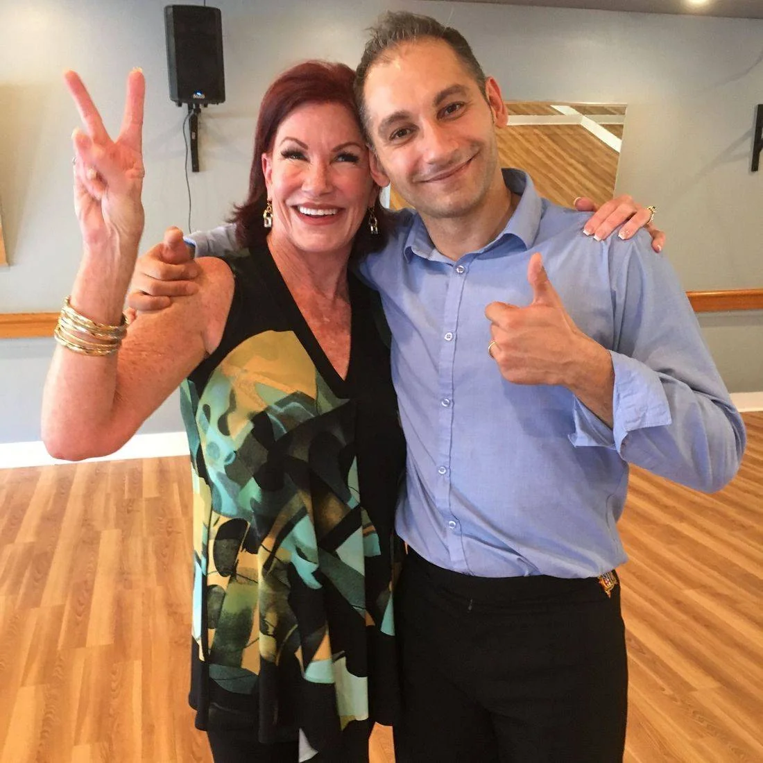 Two dancers smiling together at the studio